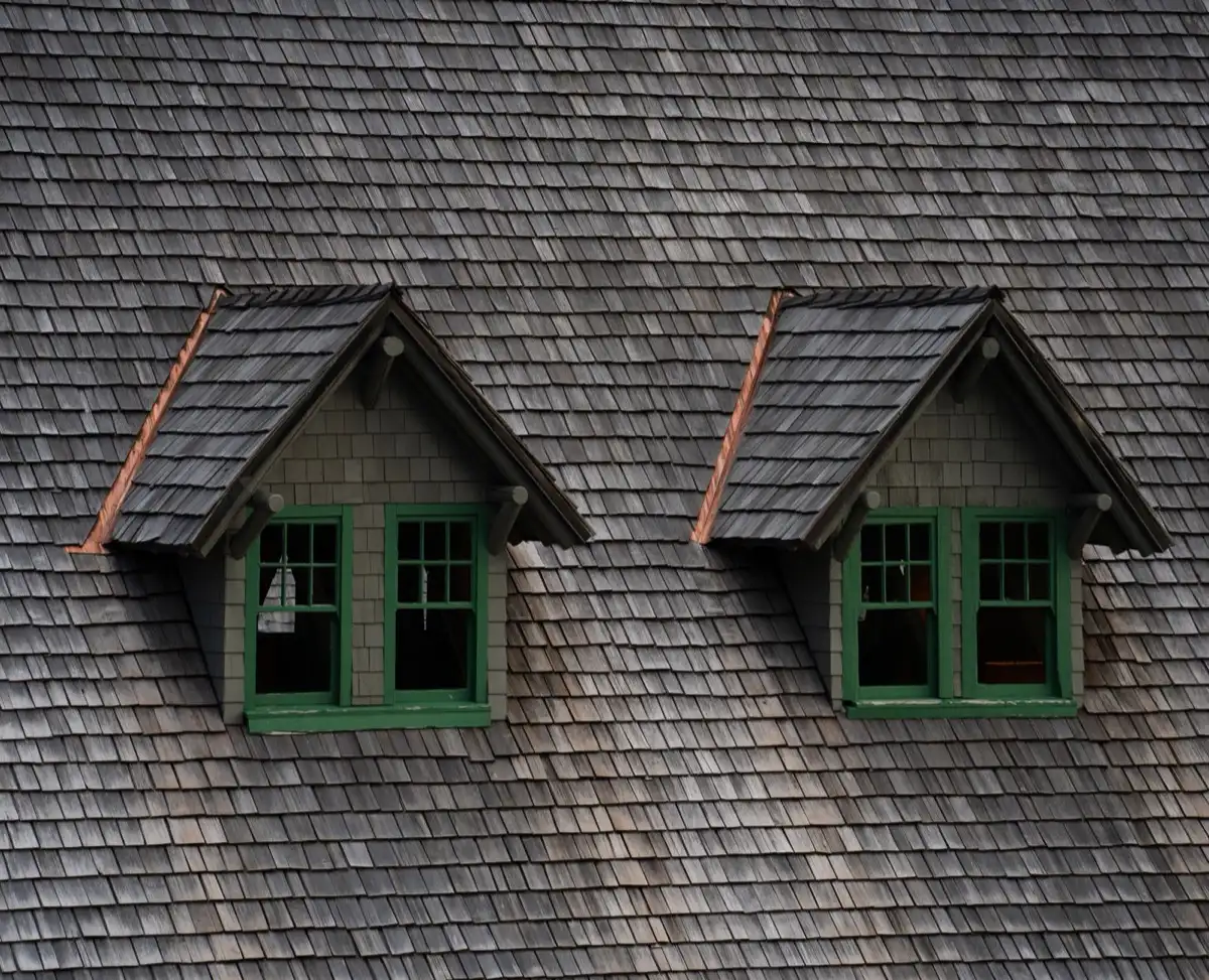 Dormers on a shingle roof in Modesto, CA, where step flashing and kickout flashing carry water past the walls